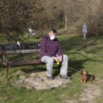 man wearing face mask with his dog during pandemic 2020